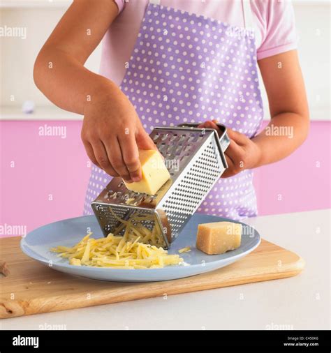 Girl Grating Cheese Close Up Stock Photo Alamy