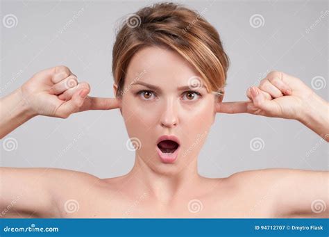 Woman With Open Mouth Closing Her Ears With Fingers Stock Image