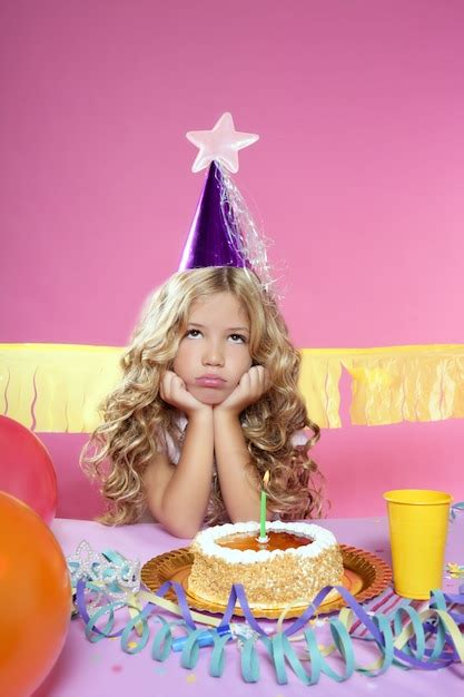 Premium Photo Bored Little Blond Girl Birthday Party With Candle Cake