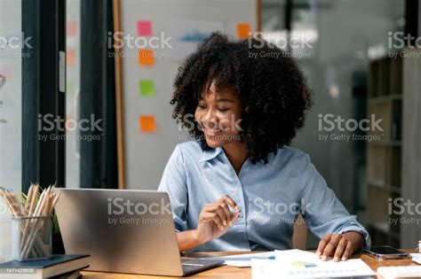 African American Businesswoman Working Inside Office With Documents And