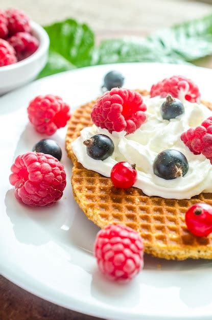 Premium Photo Belgian Waffles With Whipped Cream And Fresh Berries