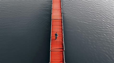 Premium AI Image A Man Walks Across A Red Bridge That Has A Red