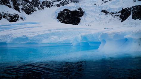 Icebergs In The Oceans Near Paradise Bay On An Overcast Day With Dark ...