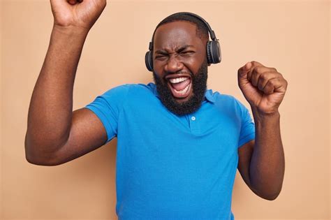 Free Photo Bearded Man Laughs Happily And Dances From Great Success