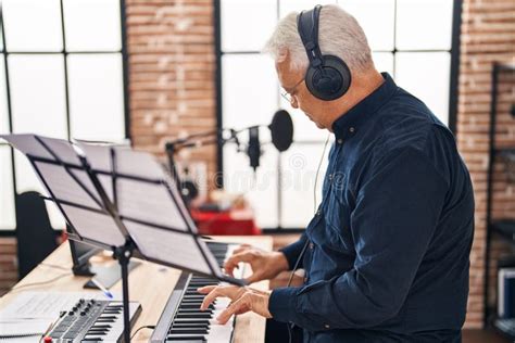 Senior Man Musician Playing Piano Keyboard At Music Studio Stock Image