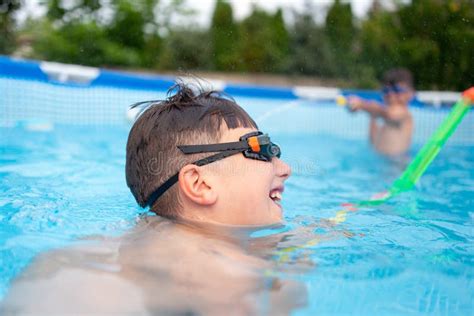 Happy Little Kids in Pool Shooting with Water Gun Stock Photo - Image ...