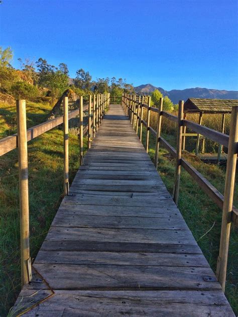 A Wooden Walkway Leading To The Top Of A Hill