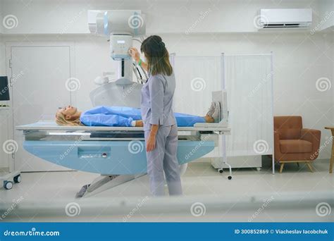 Radiologic Technologist Is Preparing Female For Radiography In Clinic