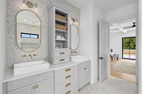 White Bathroom With Brass Oval Mirrors | HGTV