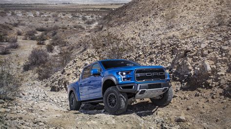 Blue Ford F 150 Raptor Pickup Vehicle Is Driving Up From Slanting Area