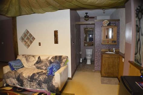 A Living Room Filled With Furniture Next To A Bathroom