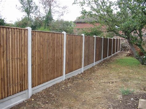 A Wooden Fence Next To A Tree In A Yard