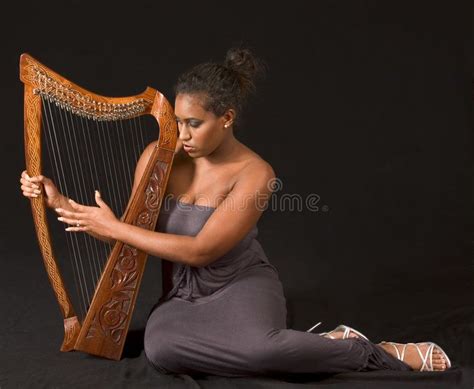 Man Playing The Harp