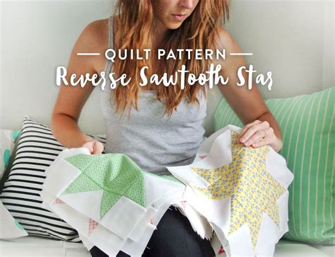 A Woman Sitting On Top Of A White Couch Next To Pillows And Quilting