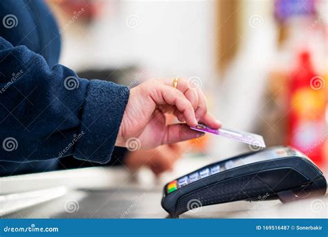 Close Up Of Cashier Is Using Contactless Credit Card Pos Terminal To