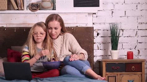 Mother And Daughter Watching Cartoons On Laptop — Stock Video