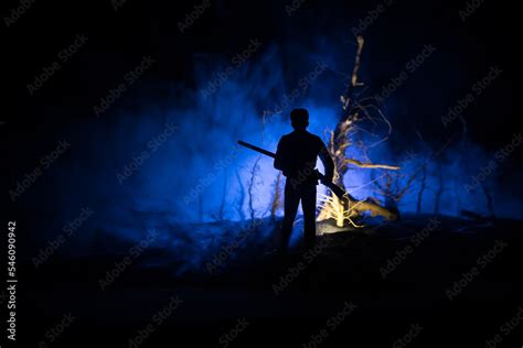 Silhouette of person standing in the dark forest. Horror halloween ...