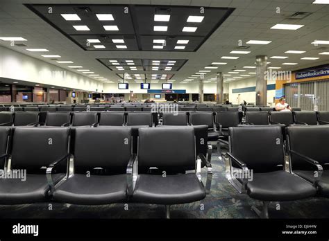 Airport Terminal At Gate Airport Seats With One Passenger Traveler