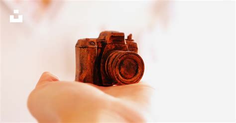 red camera scale model  human hand photo  camera photography