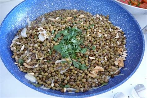 A Blue Bowl Filled With Lentils And Parsley