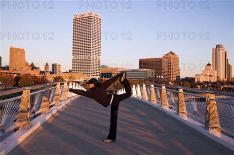 USA Wisconsin Milwaukee Woman Doing Yoga On Bridge In City Photo