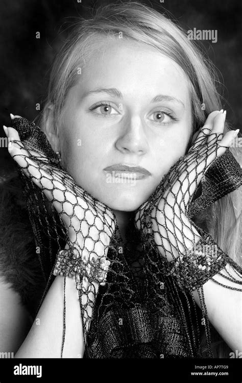 Portrait Of A Young Girl With Long Blonde Hair Holding Her Face In Her