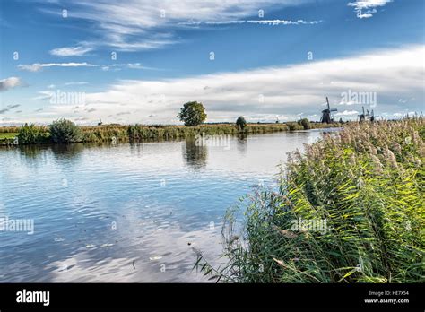 Dutch Landscape With A Canal And Grass Fields With Mirror Reflection Of