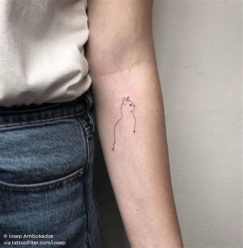 A Woman S Arm With A Small Cat Tattoo On The Left Side Of Her Arm