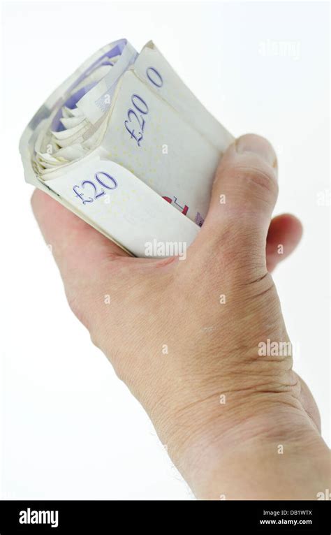 Hand Holding Rolled Up Twenty Pound Notes Stock Photo Alamy