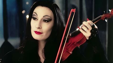 a woman with long black hair holding a violin in her right hand and ...