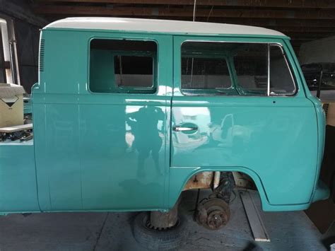 An Old Blue Van Is Parked In A Garage