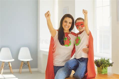 Mothers Day Girl And Mother In Superhero Costume Hug Smiling At Room