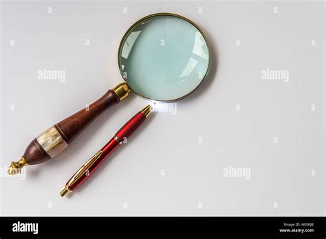 Magnifying glass and pen Stock Photo - Alamy 