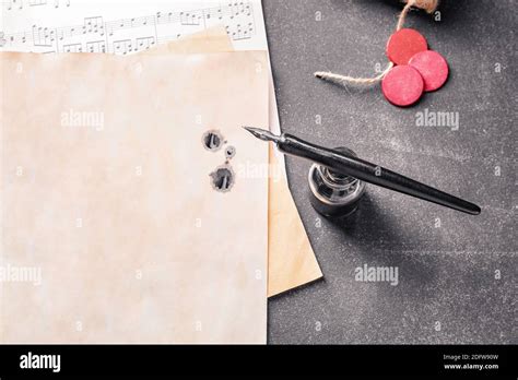 Nib Pen Inkwell And Musical Note Sheets On Black Table Stock Photo Alamy