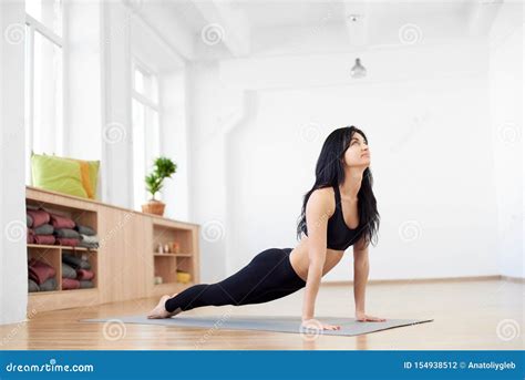 Happy Brunette Fitness Model Preparing To Workout Standing In Yoga
