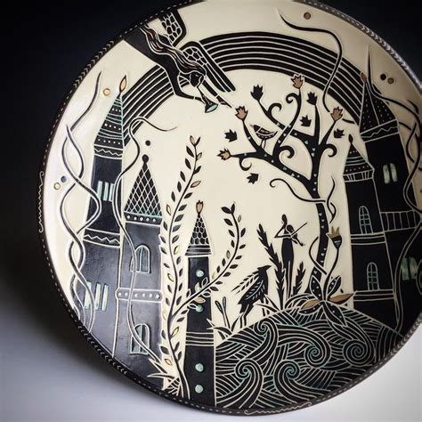 A Black And White Plate With An Image Of A Castle In The Sky On It