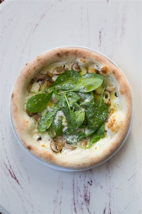 Whole Neapolitan Pizza With Green Basil Leaves And Cheese Stock Photo