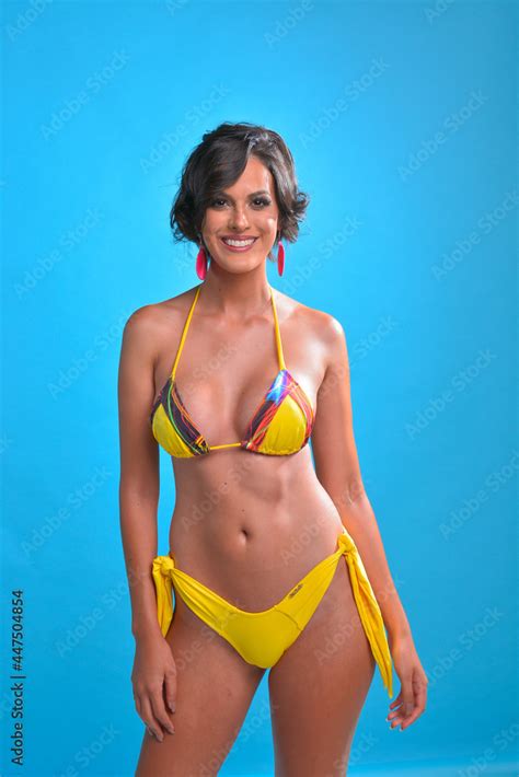 Professional Photo Woman In Yellow Bikini Blue Background Brazilian Smile Short Hair Stock