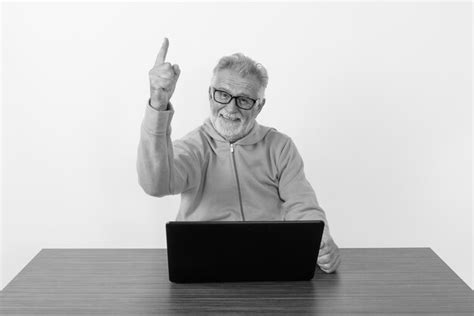 Premium Photo Man Using Mobile Phone While Sitting On Table