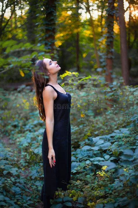 Vertical Photo of a Beautiful Woman Standing on a Forest Background ...