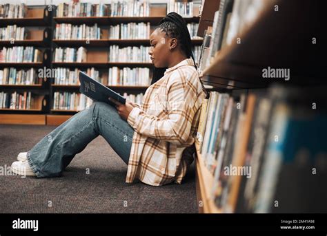 Library College Student And Black Woman Reading Books On Ground Floor