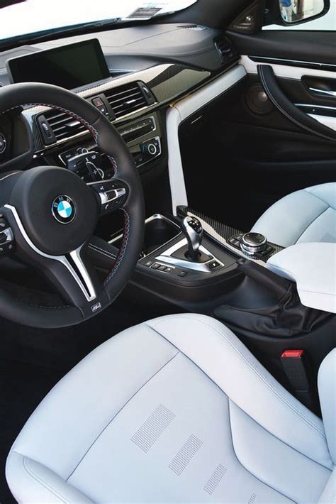 The Interior Of A Modern Car With White Leather And Black Trim