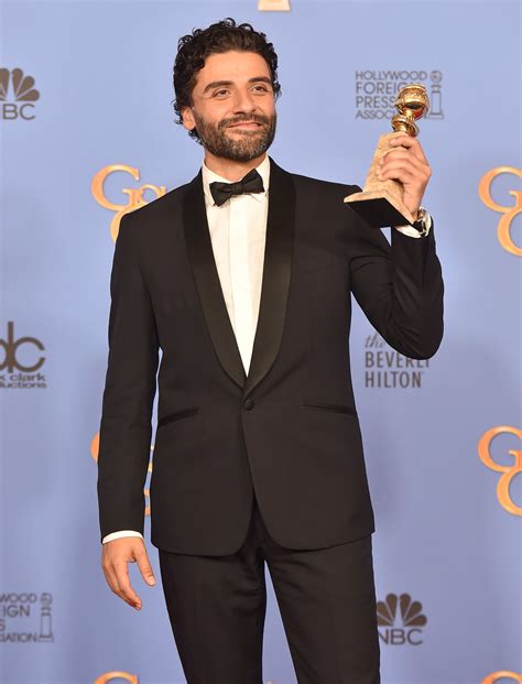 9 Photos Of Oscar Isaac Proudly Gazing At His Golden Globe