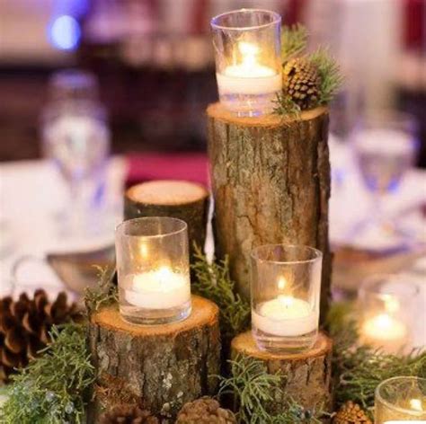 Candles Are Placed On Logs With Pine Cones And Greenery In The Centerpieces