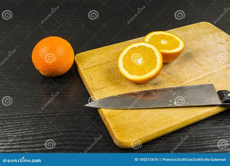 The Orange Is Cut In Half On A Chopping Board Stock Image Image Of