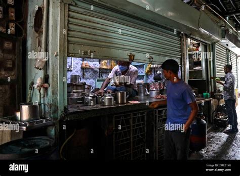 A Shopkeeper Sells Tea From His Half Closed Shop During Relaxation