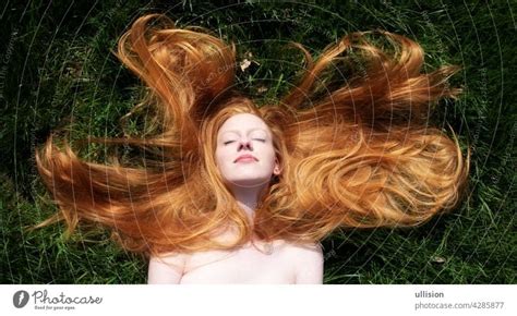 Portrait Of A Beautiful Young Sexy Red Haired Woman Lying In The