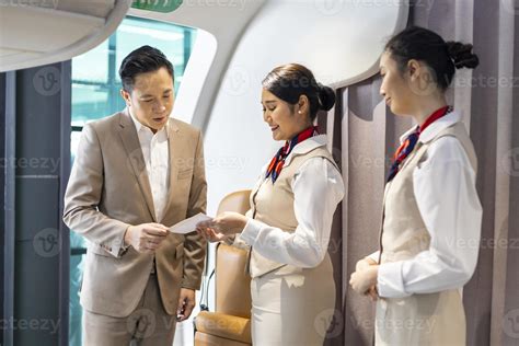 Flight Attendant Is Welcoming And Checking Passenger Boarding Pass In Business Class And Show