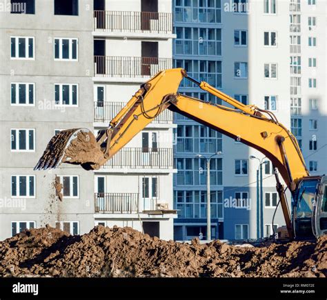 Yellow Excavator Digging The Ground At The Construction Site Stock