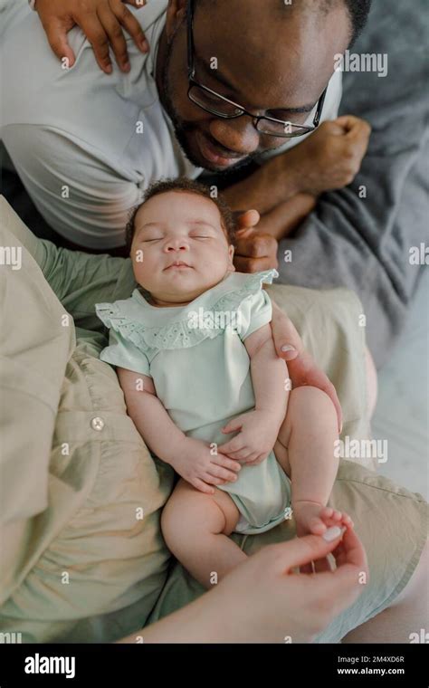 Smiling Father And Mother With Baby Girl At Home Stock Photo Alamy